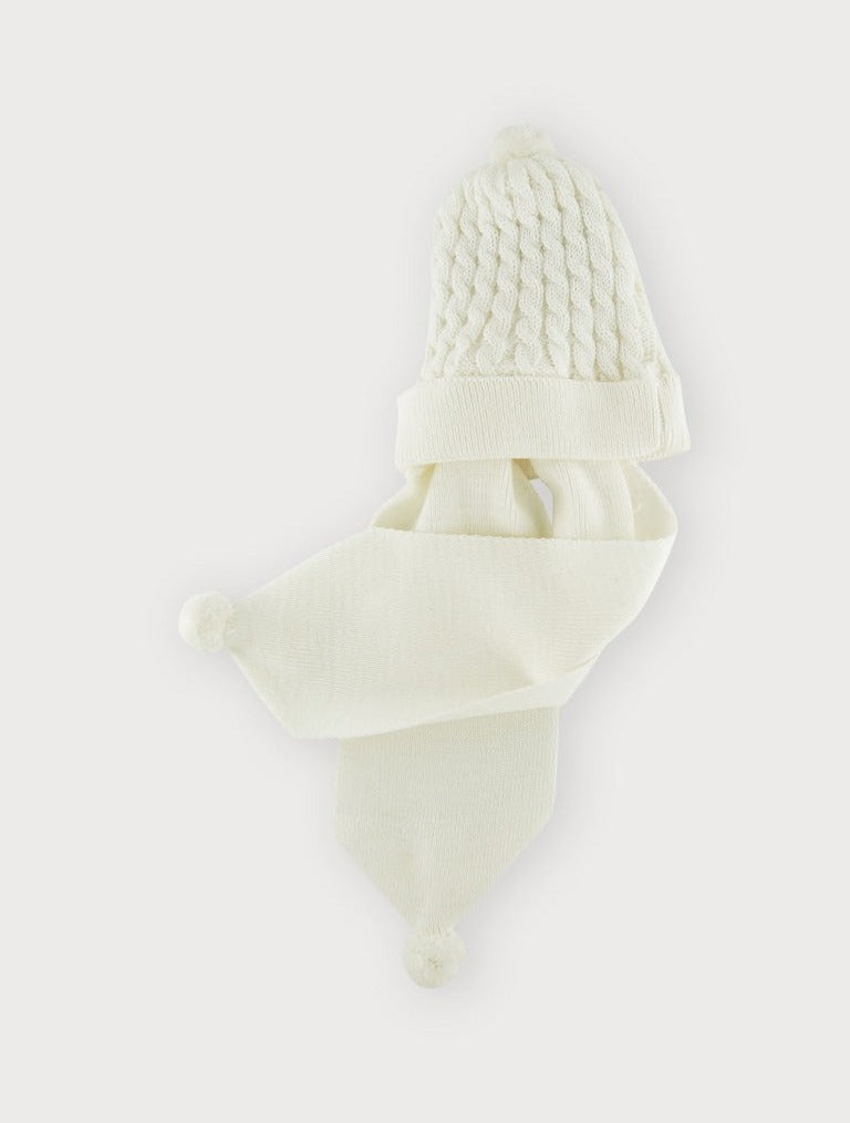 Cream cable knit hat and attached scarf with pom pom trims