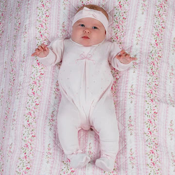 Pale pink velour babygrow with embroidered spots and bow. With matching pink headband